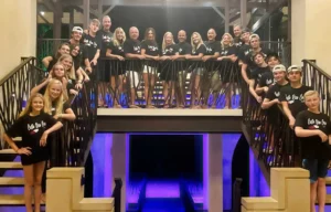 Large group of multiple families smiling on a staircase during their Costa Rica multi-family vacation at Vista Hermosa Estate