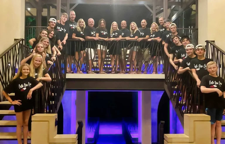 Large group of multiple families smiling on a staircase during their Costa Rica multi-family vacation at Vista Hermosa Estate