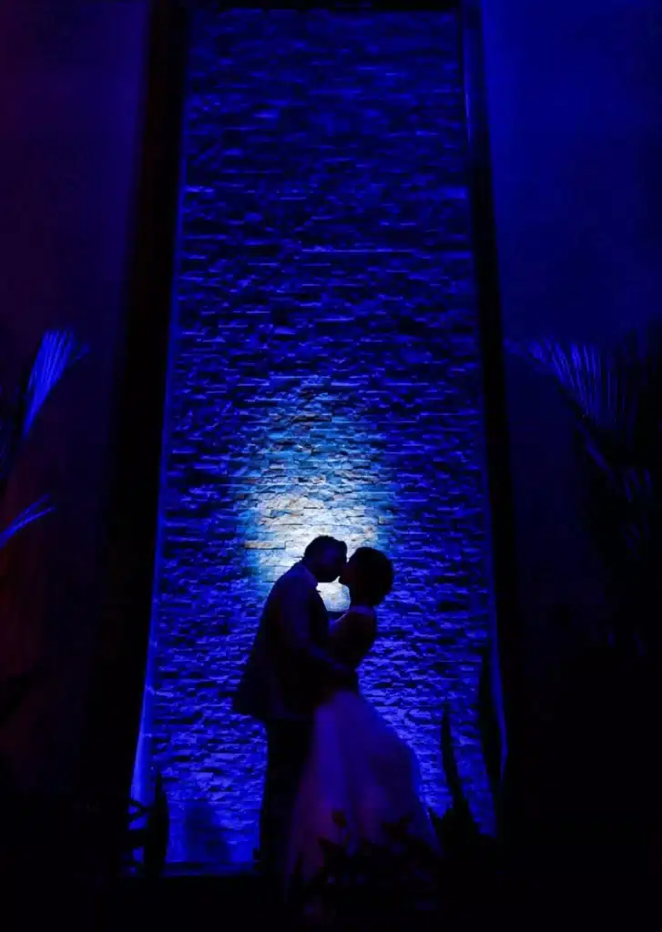 Costa Rica wedding: a kiss captured at night as newlyweds embrace under dramatic lighting on their tropical destination wedding day