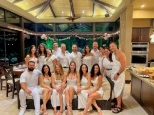 Costa Rica couples group trip with multiple couples celebrating together at a villa dressed in white for an anniversary vacation