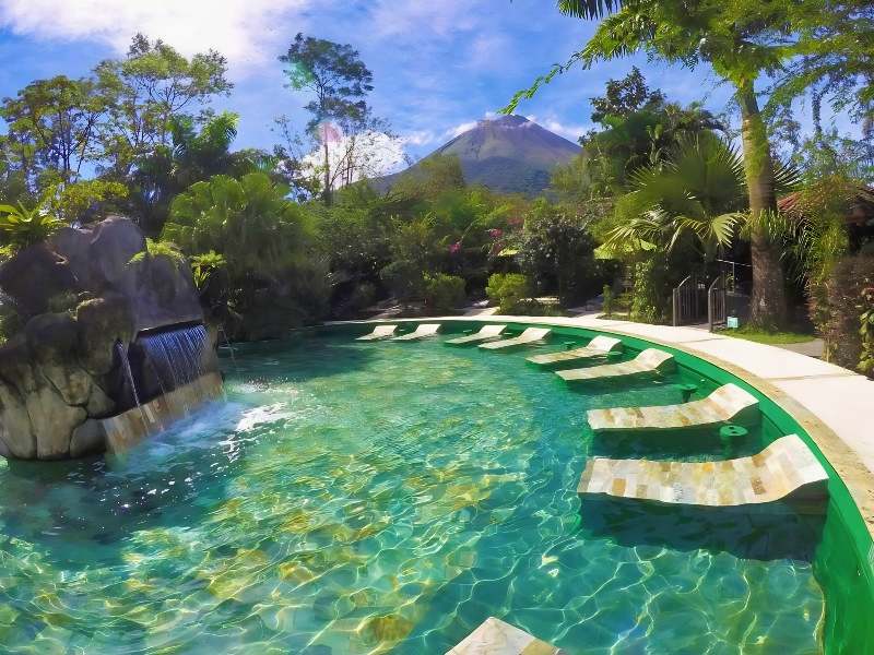 A pool with lounge chairs at Paradise Hot Springs Boutique Hotel