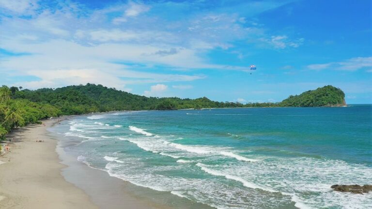 Stunning view of a tropical beach town in Costa Rica, with golden sands & lush greenery, ideal for a dream beach vacation