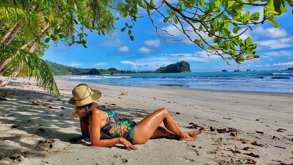 Playa Playitas Beach Manuel Antonio Costa Rica A woman with toes in the sand low tide at Playa Playitas Beach Manuel Antonio Costa Rica