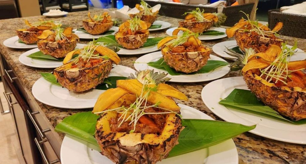 Costa Rica house rentals with chef serving gourmet appetizers in pineapples in an all-inclusive villa with local and international flavors